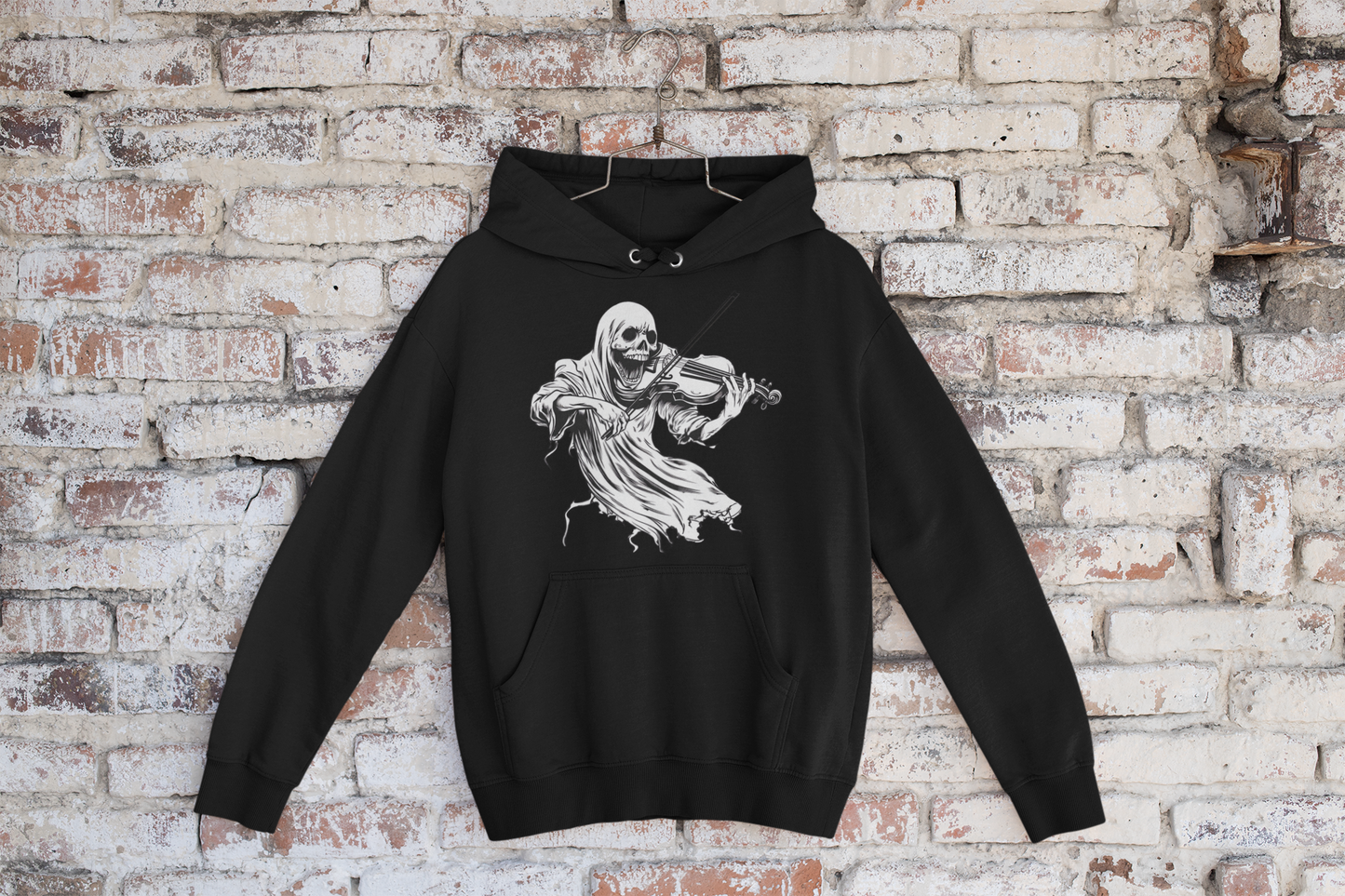 Black hoodie with a skeleton playing violin design on a brick wall background