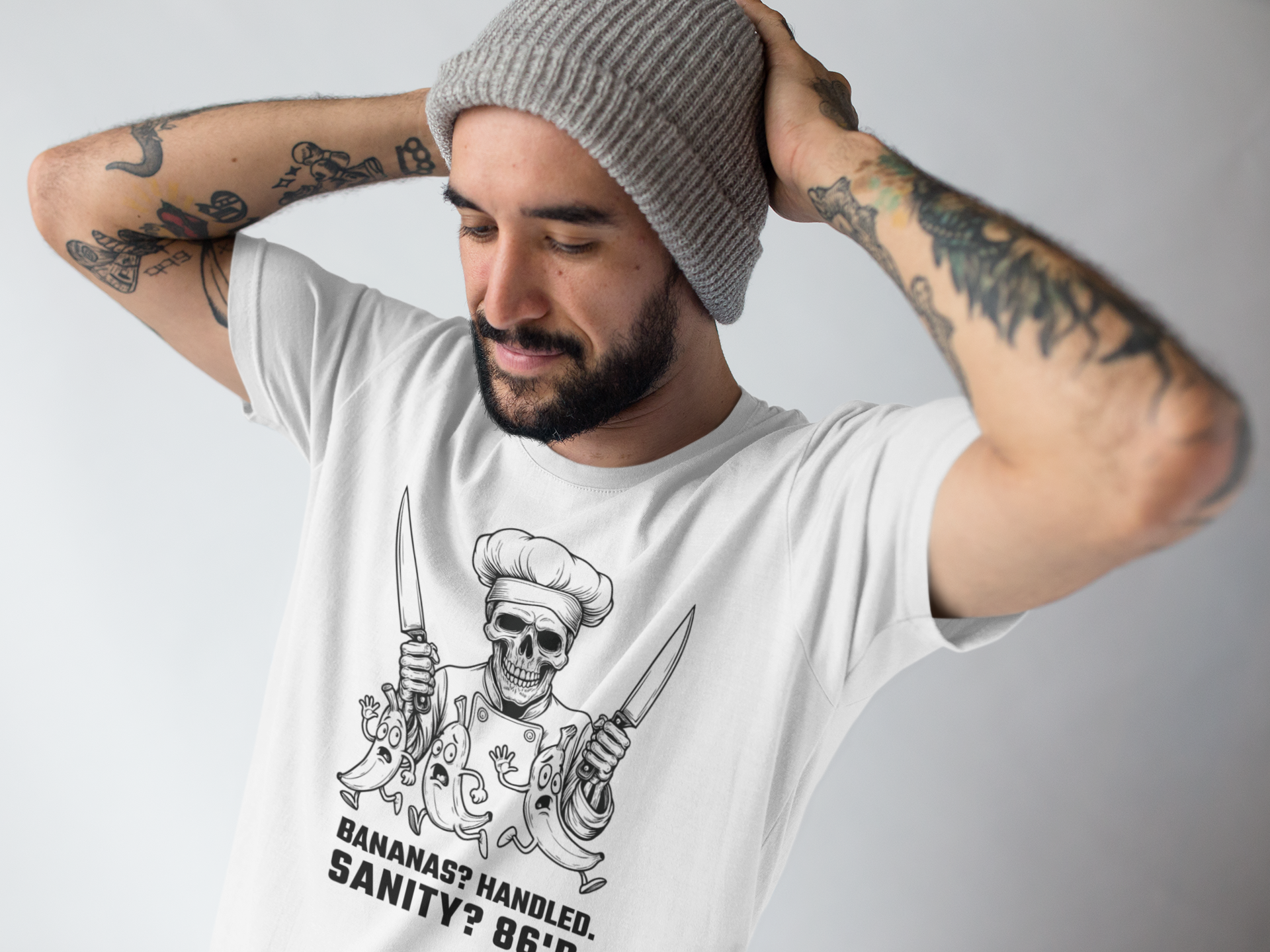 Man wearing a white t-shirt with a graphic design and text, posing against a plain background.