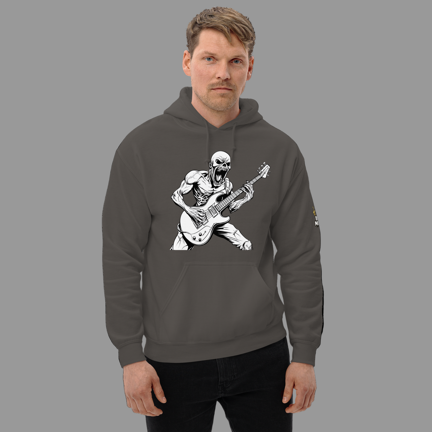 Man wearing a gray hoodie with a skeleton playing guitar design on a white background