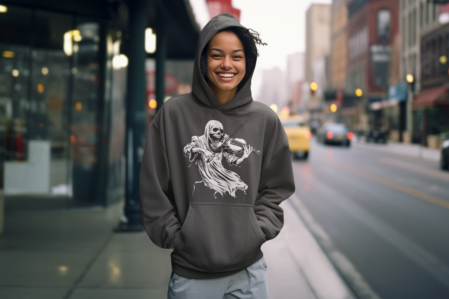 Person wearing a hoodie with a graphic design on a city street