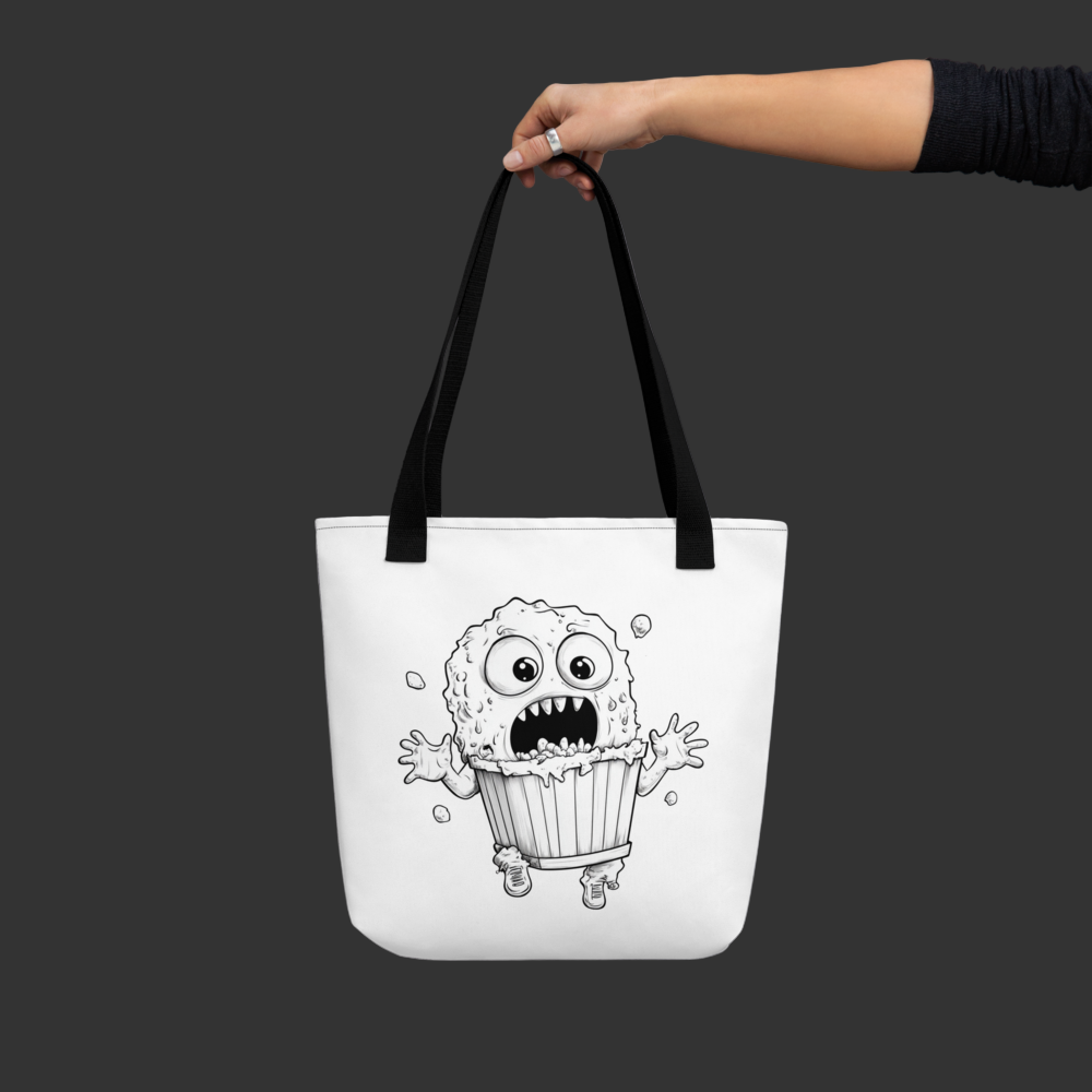 Tote bag with a black and white illustration of a creature in a trash can, held by a hand against a gray background.